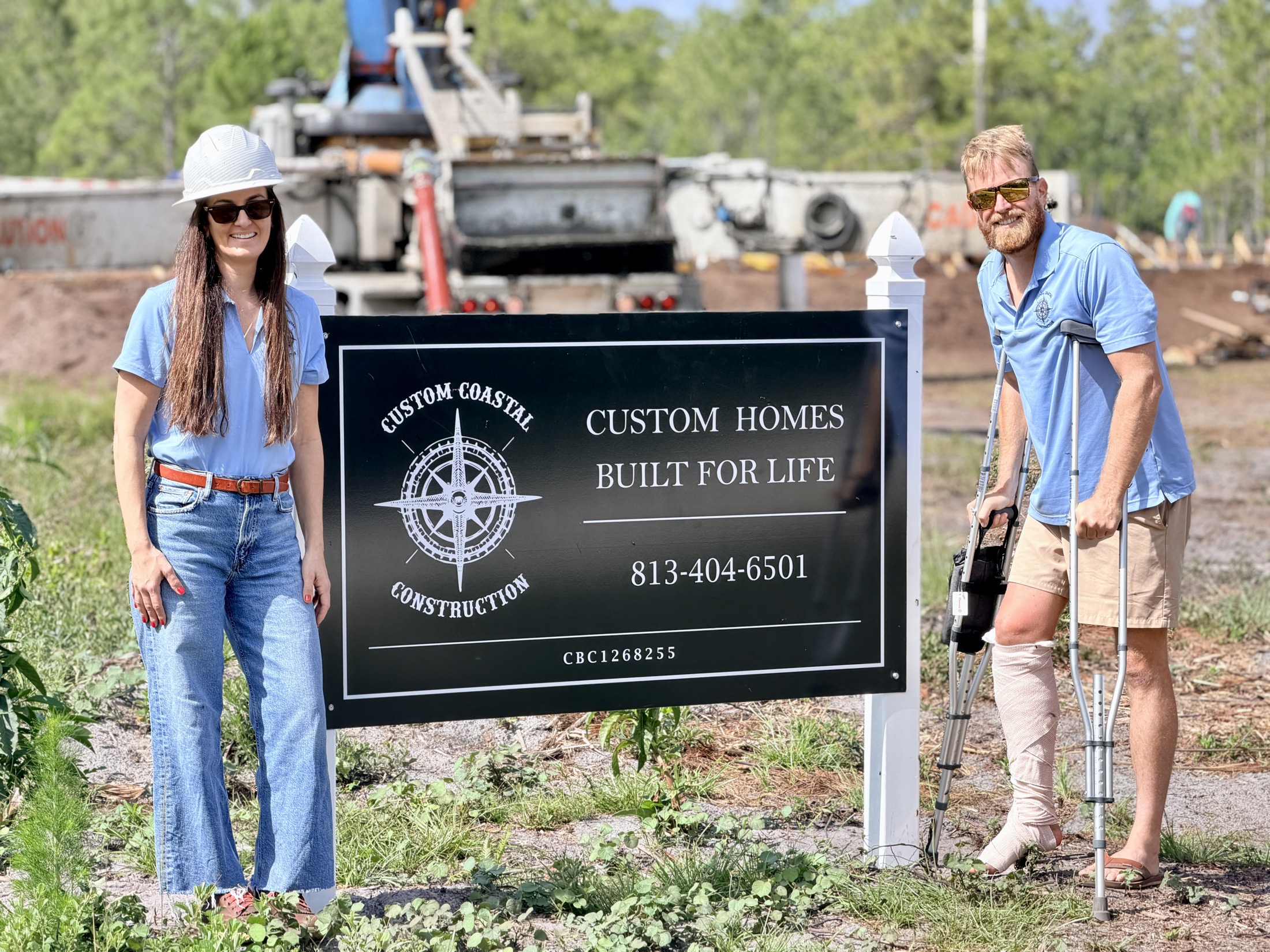 Joe and Vanessa Burns at a Custom Coastal Construction jobsite sign